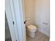 Neutral toned powder room featuring a standard toilet, flooring and chrome hardware at 13217 Tollcross Way, Winter Garden, FL 34787