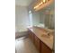 Well-lit bathroom with double sinks, a large mirror and a separate tub and shower at 14020 Sanibel Isle Dr, Orlando, FL 32824