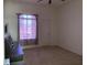 Empty bedroom with neutral carpet features a double door closet, and a large window at 14020 Sanibel Isle Dr, Orlando, FL 32824