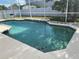 Sparkling screened-in pool with blue-tiled trim and ample space for entertaining at 14020 Sanibel Isle Dr, Orlando, FL 32824