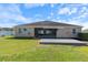 Home's backyard showcasing a deck, green grass, and partial view of the screened patio, great for outdoor at 1407 Leitrim Loop, Apopka, FL 32703