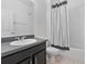 Bathroom showcasing vanity with a dark countertop and a shower with a decorative curtain at 1407 Leitrim Loop, Apopka, FL 32703