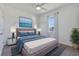 Comfortable main bedroom featuring cool color tones, a ceiling fan, and natural lighting at 1407 Leitrim Loop, Apopka, FL 32703