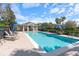 Community pool featuring plenty of lounge chairs and umbrellas on a sunny day at 1407 Leitrim Loop, Apopka, FL 32703