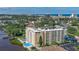 High-angle view of the condominium building surrounded by trees and cityscape in the distance at 145 N Halifax Ave # 601, Daytona Beach, FL 32118