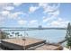 Wide angle view of the ocean with bridges, buildings, and boats under a cloudy blue sky at 145 N Halifax Ave # 601, Daytona Beach, FL 32118