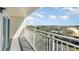 Condo balcony overlooking trees and neighborhood buildings under a partly cloudy sky at 145 N Halifax Ave # 601, Daytona Beach, FL 32118