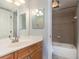 This bathroom features a clean vanity with an adjacent tiled shower/tub combo at 145 N Halifax Ave # 601, Daytona Beach, FL 32118