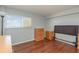 This cozy bedroom features a window with natural light and warm wood laminate flooring at 145 N Halifax Ave # 601, Daytona Beach, FL 32118