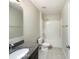 Bathroom featuring a granite vanity top, a combined shower-bathtub, toilet, and tiled flooring at 15120 Zenith Ave, Mascotte, FL 34753