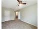 Spacious bedroom featuring neutral carpet, light walls, and door leading to bathroom at 15120 Zenith Ave, Mascotte, FL 34753