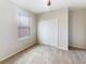 Bedroom featuring a closet, neutral colors, and a window providing natural light at 15120 Zenith Ave, Mascotte, FL 34753