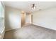 Spacious living room with neutral carpet, light walls, and great natural light from the large windows at 15120 Zenith Ave, Mascotte, FL 34753