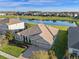 Aerial view of the home showing pond, landscaping, and close proximity to other homes at 15993 Johns Lake Overlook Dr, Winter Garden, FL 34787