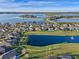 Picturesque aerial view of a home nestled by a pond with a water feature and lush greenery at 15993 Johns Lake Overlook Dr, Winter Garden, FL 34787