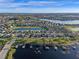 Expansive aerial view of waterfront homes with private docks on a serene lake at 15993 Johns Lake Overlook Dr, Winter Garden, FL 34787