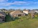 Expansive backyard view showcasing a well-kept lawn and the home's exterior at 15993 Johns Lake Overlook Dr, Winter Garden, FL 34787