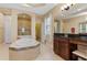 This bathroom features a soaking tub, a vanity area and a step-in shower behind a glass enclosure at 15993 Johns Lake Overlook Dr, Winter Garden, FL 34787