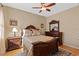 This cozy bedroom features a wood frame bed and hardwood floors at 15993 Johns Lake Overlook Dr, Winter Garden, FL 34787