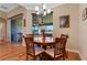 Cozy dining area with wood floors, slider to patio, and chandelier lighting at 15993 Johns Lake Overlook Dr, Winter Garden, FL 34787