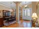 Spacious foyer with hardwood floors, chandelier, and a decorative glass front door at 15993 Johns Lake Overlook Dr, Winter Garden, FL 34787