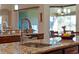 Close-up of kitchen island with granite countertop, stainless steel faucet, and views to dining area at 15993 Johns Lake Overlook Dr, Winter Garden, FL 34787