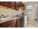 Bright laundry room with a washer and dryer, sink, and lots of cabinet space at 15993 Johns Lake Overlook Dr, Winter Garden, FL 34787