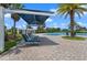 Resort-style pool area features lounge chairs, sunshades, and lush tropical landscaping at 15993 Johns Lake Overlook Dr, Winter Garden, FL 34787