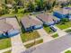 Aerial view of a neighborhood featuring well-maintained homes with green lawns and modern driveways at 1671 Spray Ter, St Cloud, FL 34771