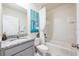 Well-lit bathroom featuring a granite-topped vanity and a shower-tub combination with a white shower curtain at 1671 Spray Ter, St Cloud, FL 34771