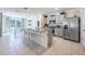 Modern kitchen with stainless steel appliances, granite countertops, and a center island with seating at 1671 Spray Ter, St Cloud, FL 34771