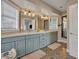 Elegant bathroom featuring double vanity, stylish mirrors, and patterned tile floors at 1750 Winchester Dr, Winter Park, FL 32789