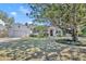 Charming home exterior with white painted brick, a lush lawn, and mature landscaping at 1750 Winchester Dr, Winter Park, FL 32789