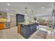 Spacious kitchen island with seating, pendant lighting, and views of the adjoining living area at 1750 Winchester Dr, Winter Park, FL 32789