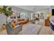 Cozy living room featuring a plush rug, comfortable seating, and large windows showcasing the landscape at 1750 Winchester Dr, Winter Park, FL 32789