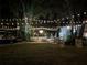 Backyard event space with string lights, mature trees, and an inviting atmosphere at 2614 W Ponkan Rd, Apopka, FL 32712