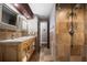 Bathroom featuring double sink vanity, warm lighting, and a walk-in shower, creating a spa-like experience at 2614 W Ponkan Rd, Apopka, FL 32712