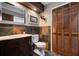 This bathroom features multicolored wall tiles, a dark wood vanity, and an enclosed toilet at 2614 W Ponkan Rd, Apopka, FL 32712