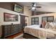 Bedroom featuring a dresser, rustic barn door, wood flooring, and decorative painting, offering a cozy retreat at 2614 W Ponkan Rd, Apopka, FL 32712