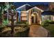 Elegant home exterior featuring brick accents, an arched entryway, and a tranquil fountain at 2614 W Ponkan Rd, Apopka, FL 32712