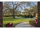 Manicured front yard with mature trees, a circular driveway, and a water fountain feature at 2614 W Ponkan Rd, Apopka, FL 32712