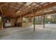 An outdoor stall with a concrete pad, wooded beam roof, metal roof, and wooden beams at 2614 W Ponkan Rd, Apopka, FL 32712