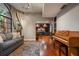 Cozy living room featuring hardwood floors, a comfortable couch, and a view to the wet bar at 2614 W Ponkan Rd, Apopka, FL 32712