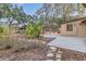 Landscaped backyard showcasing a patio, lush greenery, and stone pathway, creating a serene outdoor space at 2643 Nova Dr, Apopka, FL 32703