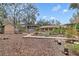 Beautifully landscaped backyard featuring a wooden pergola and lush greenery, creating a serene outdoor space at 2643 Nova Dr, Apopka, FL 32703