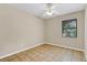 Bedroom featuring tile flooring, a window, and ceiling fan at 2643 Nova Dr, Apopka, FL 32703