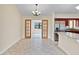 Bright dining room features tile flooring, chandelier, and wood-framed doorway leading to the additional room at 2643 Nova Dr, Apopka, FL 32703