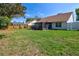 Large backyard featuring green grass, wooden fence, and a screened-in lanai, perfect for outdoor relaxation and entertainment at 304 Silver Pine Dr, Lake Mary, FL 32746