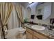 Bathroom featuring granite countertop, tiled floors, and a shower-tub combo at 304 Silver Pine Dr, Lake Mary, FL 32746