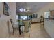 Bright dining area with glass table and chairs adjacent to the kitchen and open to the living room at 304 Silver Pine Dr, Lake Mary, FL 32746